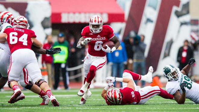 Indiana University junior Tevin Coleman (6) rushes the ball into the Michigan State secondary during the first half of action. Indiana University hosted Michigan State University in Big Ten football action, Saturday, October 18, 2014, in Bloomington, Ind.