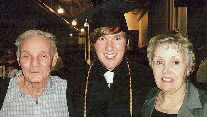 Herchell Bridges at his Fairview High School graduation in 2009 with his grandparent Louise and Edward Fondaw.