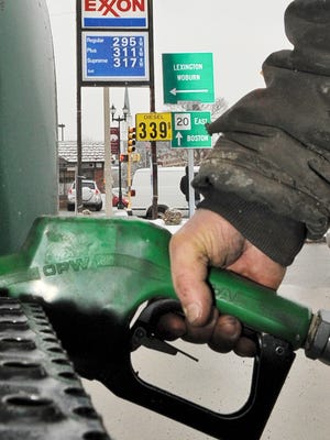 A man pumps gas at an Exxon gas station in Waltham, Mass., in this 2008 file photo