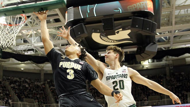Jan 24, 2017; East Lansing, MI, USA; Purdue Boilermakers guard Carsen Edwards (3) shoots the ball past Michigan State Spartans guard Matt McQuaid (20) during the first half at the Jack Breslin Student Events Center. Mandatory Credit: Mike Carter-USA TODAY Sports