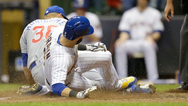 Brewers leftfielder Ryan Braun slides into home after a wild pitch to beat the Cubs, 2-1, in 11 innings on Friday night at Miller Park.