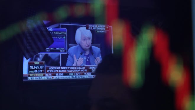 U.S. Federal Reserve Chair Janet Yellen is reflected in a trader's screen on the floor of the New York Stock Exchange on Dec. 14, 2016. (EPA/ANDREW GOMBERT)