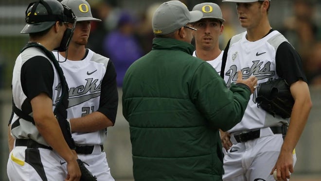 Oregon starting pitcher Cole Irvin (right) listens to head coach George Horton (center) during the Ducks' 9-0 loss to Oregon State in a Civil War baseball game at PK Park, in Eugene, on Saturday, May 18, 2013.