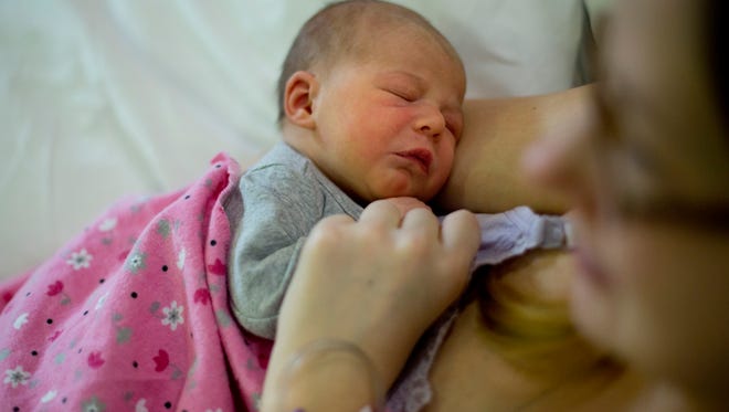 Robyn Bishop holds her newborn daughter, Arabella, Saturday, Jan. 2, at St. John River District Hospital in East China Township. Baby Arabella was born at 12:26 a.m. Friday.