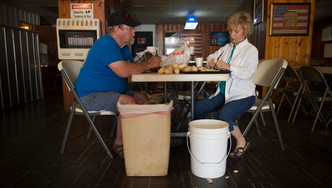 U.S. Army veteran Robert Cobb, left, and Judy Griffin peel and cut potatoes in preparation for the Friday night fish fry Tuesday afternoon. The proprietors of the New Haven, Ill., American Legion Post 1141 have turned the failing business around since they took the reins a couple of years back.