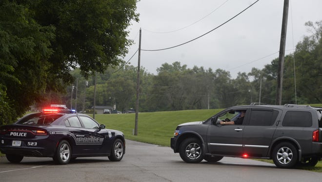 Richmond Police Department vehicles guard the entrance to Middlefork Reservoir at the intersection of Reid Parkway and Sylvan Nook Drive on Friday afternoon.