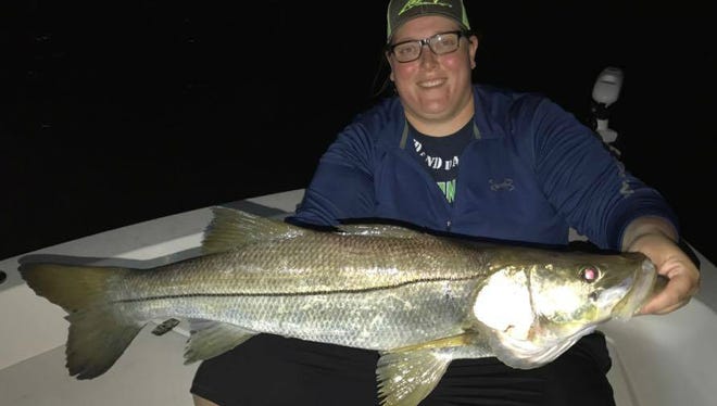 Jennifer Rohl, of Ashern Manitoba, Canada fished with her dad, Kurt Rohl of Port St. Lucie, Wednesday to catch and release her personal best snook, an overslot beauty which hit a Yo-Zuri 3D lure around an unlit dock.