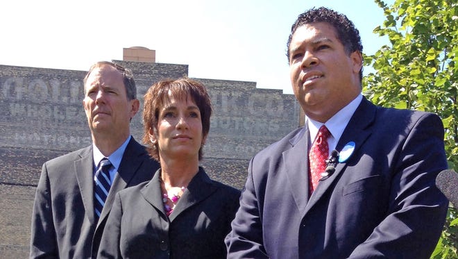 State Rep. Jon Richards, left, and Dane County District Attorney Ismael Ozanne, right, endorse Jefferson County District Attorney Susan Happ for Wisconsin attorney general during a news conference in Milwaukee on Friday, Aug. 15, 2014.