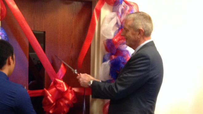 Camden County College President Donald Borden (right) cuts the ribbon to the Veterans Outpost Lounge.