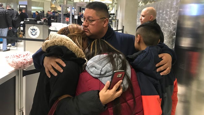 Jorge Garcia, 39, of Lincoln Park, Mich., hugs his wife, Cindy Garcia, and their two children Jan. 15, 2018, at Detroit Metro Airport moments before being forced to board a flight to Mexico to be deported.