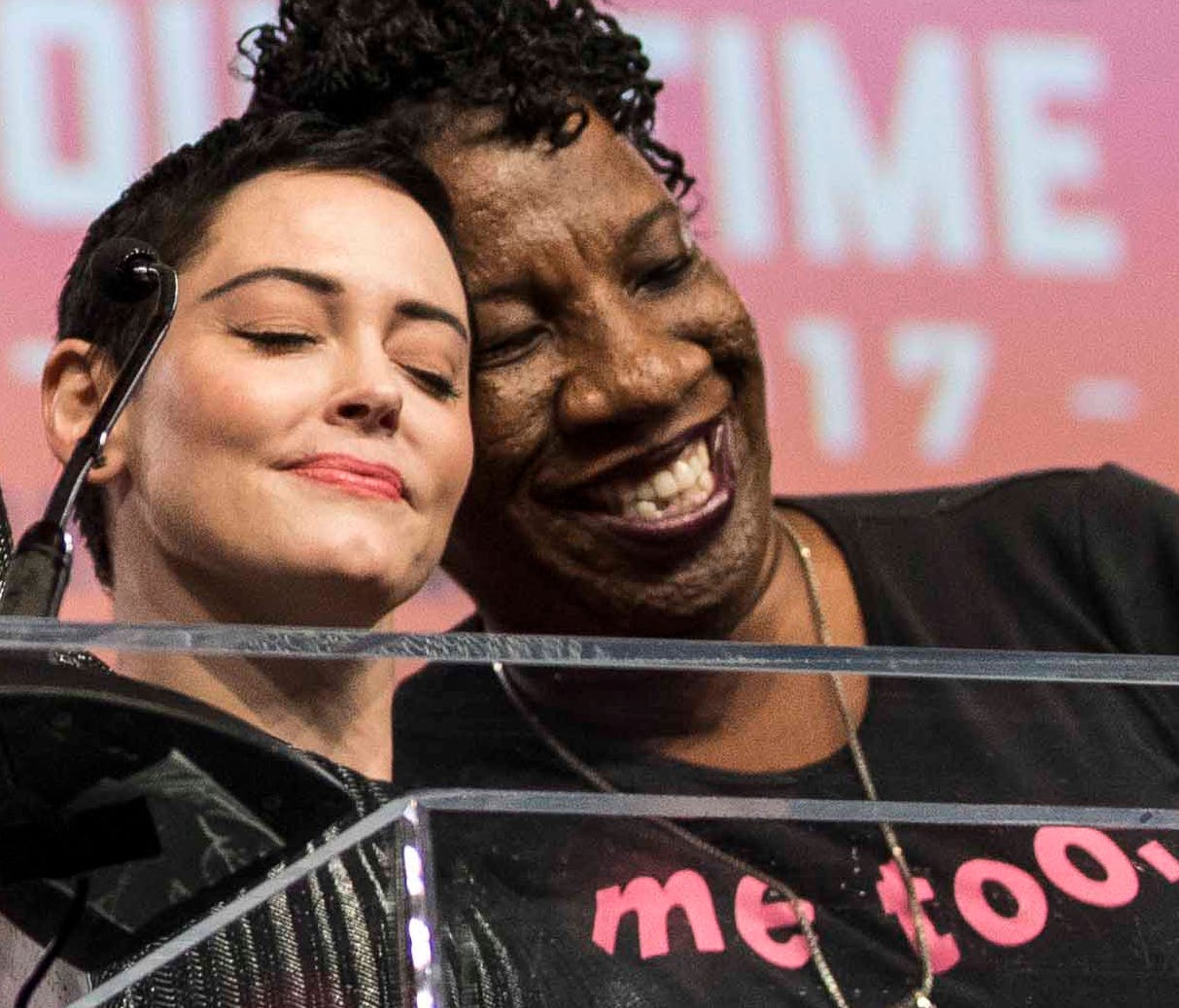 McGowan hugs Tarana Burke (right) the creator of #MeToo, as she was being introduced to the stage during Fighting for Survivors of Sexual Assault in the Age of Betsy DeVos during The Women's Convention at Cobo Center.