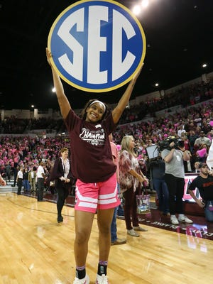 Mississippi State's Victoria Vivians (35) holds an SEC sign after No. 2-ranked Mississippi State defeated Texas A&M to claim the SEC regular season title on Sunday, February 18, 2018 at Humphrey Coliseum in Starkville.