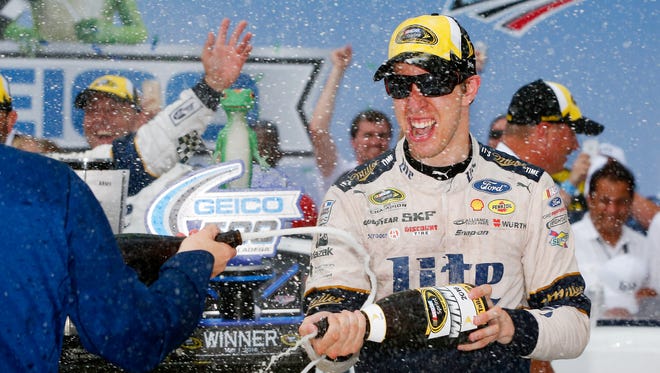 Brad Keselowski, driver of the No. 2 Miller Lite Ford, celebrates with champagne in Victory Lane after winning the NASCAR Sprint Cup Series GEICO 500 at Talladega Superspeedway on May 1, 2016, in Talladega, Alabama.