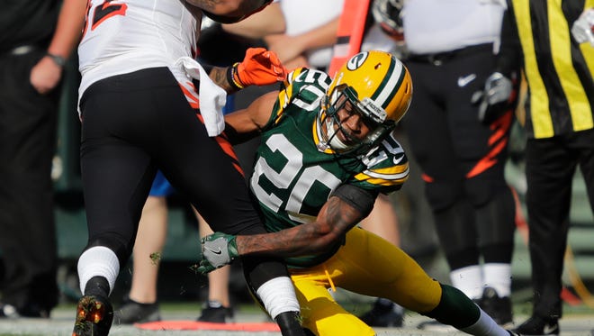 Green Bay Packers cornerback Kevin King (20) tackles Cincinnati Bengals running back Jeremy Hill (32) in the first half Sunday, September 24, 2017, at Lambeau Field in Green Bay, Wis.
