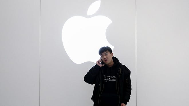 A Chinese man is on the phone outside the Apple Store on January 3, 2019 in Beijing, China. Apple Inc. lowered its revenue guidance on Wednesday, blaming China's slowing economy and weaker than expected iPhone sales, as the company's chief executive officer Tim Cook said in a letter to investors the sales problems were primarily in its Greater China region that accounts for almost 20 percent of its revenue and includes Hong Kong and Taiwan.