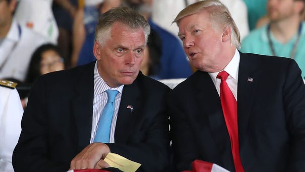 Virginia Gov. Terry McAuliffe, left, with...