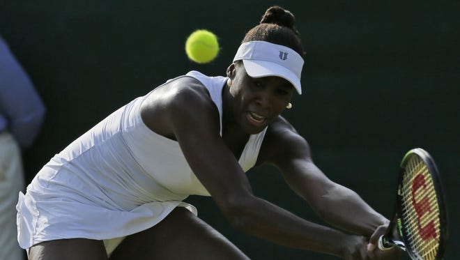 Venus Williams of the United States returns a ball to Aleksandra Krunic of Serbia during their singles match at the All England Lawn Tennis Championships in Wimbledon, London, Friday July 3, 2015. (AP Photo/Tim Ireland)