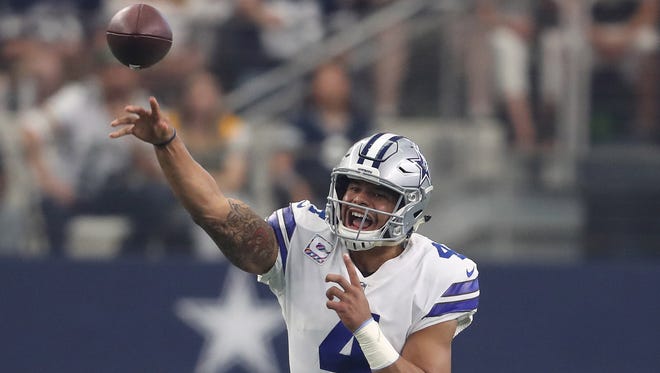 Dallas Cowboys quarterback Dak Prescott (4) throws on the run in the first quarter against the Green Bay Packers at AT&T Stadium.