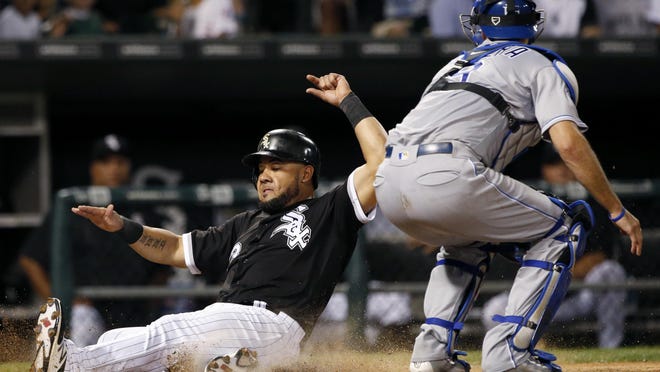 The White Sox's Melky Cabrera, left, scores on a single by Justin Morneau as Kansas City Royals catcher Drew Butera applies a late tag during the fifth inning on Friday night.