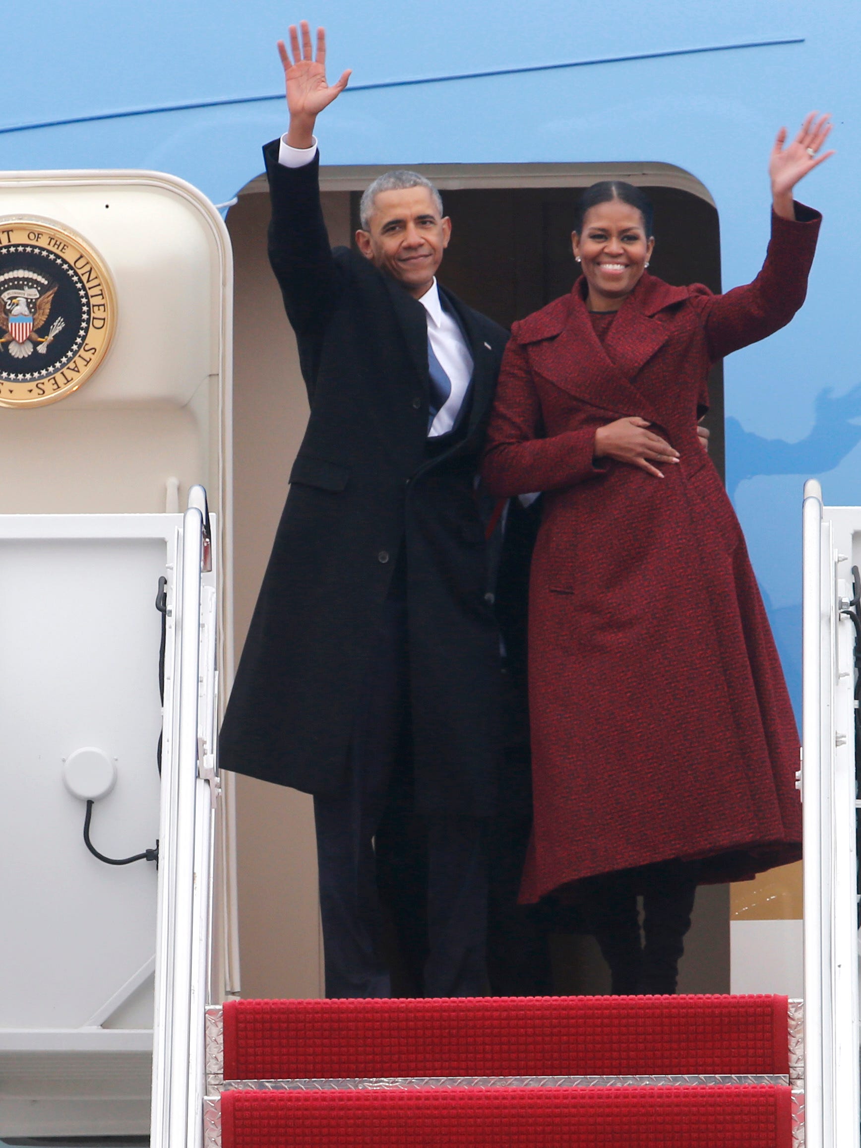 Former President Barack Obama and his wife Michelle wave as they board an Air force jet to depart Andrews Air Force base in Maryland and head to Palm Springs on Friday, Jan. 20, 2017.