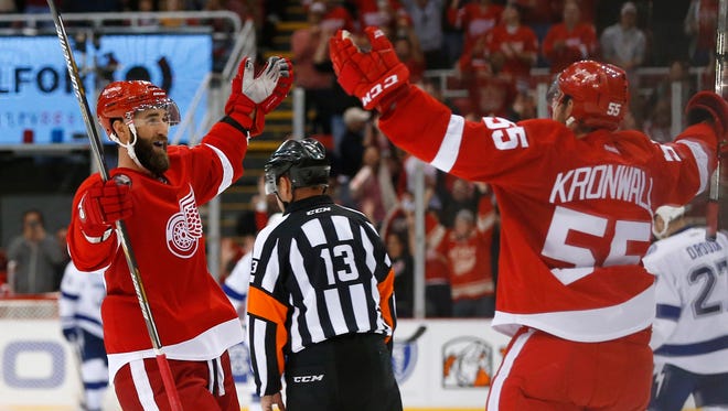 Red Wings defenseman Kyle Quincey, left, celebrates his empty net goal with Niklas Kronwall  against the Lightning in the third period on Oct. 13 at Joe Louis Arena. Detroit won 3-1.