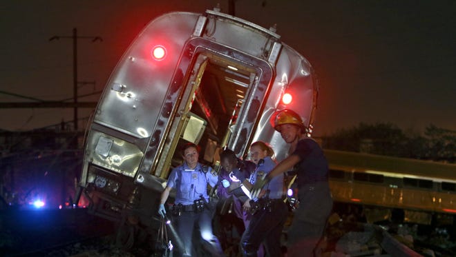 Emergency personnel work the scene of a deadly train wreck, Tuesday, May 12, 2015, in Philadelphia. An Amtrak train headed to New York City derailed and crashed in Philadelphia.