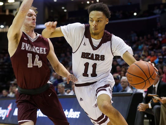Jarred Dixon (11) moves around Autry Acord (14) during