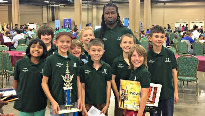 Students from the Chess Masters of Delaware show off their trophy after placing at Supernationals in Nashville, Tennessee.