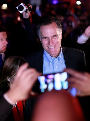 Mitt Romney is greeted by admirers at a dinner during the RNC's annual winter meeting.