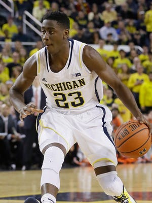 Michigan guard Caris LeVert controls the ball during the second half of an NCAA college basketball game against Illinois in Ann Arbor, Mich., Tuesday, Dec. 30, 2014. (AP Photo/Carlos Osorio)