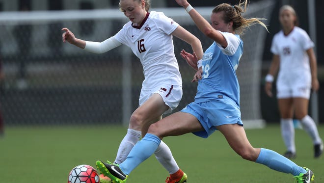 FSU's Gabby Carle dribbles past UNC’s Dorian Bailey during their match at the Seminole Soccer Complex on Sunday. 