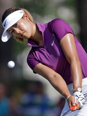 Michelle Wie chips to the 14th hole during the second round of the U.S. Women’s Open in Pinehurst, N.C., on Friday. Wie shot a 2-under 68 for a 3-shot lead over Lexi Thompson.