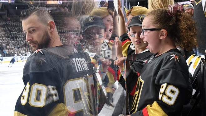 Miah Downs 11, of Nevada, reacts as Golden Knights' Tomas Tatar stands in front of her during warmups before Game 3 of the Western Conference finals against the Winnipeg Jets at T-Mobile Arena on May 16, 2018, in Las Vegas.