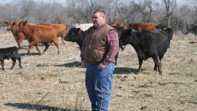 This March 10, 2017 photo shows Derek Sawyer, who farms and ranches near McPherson, Kan. He says farmers can't weather much more of the economic downturn that has hit the agricultural industry. (Travis Heying/The Wichita Eagle via AP)