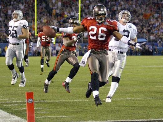 Super Bowl XXXVII (Buccaneers 48, Raiders 21): Tampa Bay's Dwight Smith races into the end zone ahead of pursuing Oakland Raiders quarterback Rich Gannon on a 44-yard interception runback for a touchdown.