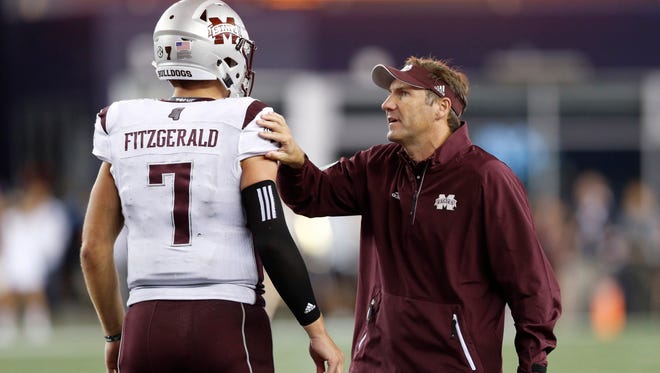 Mississippi State Bulldogs head coach Dan Mullen talks with quarterback Nick Fitzgerald.