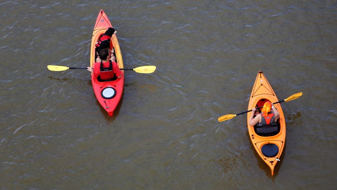 A pair of kayaks float along the Ohio River near the Public Landing.