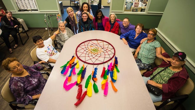 Staff and members of Active Day/Senior Care of Vineland pose for a photo with a dreamcatcher made for National Adult Day Services Week on Thursday, September 21.