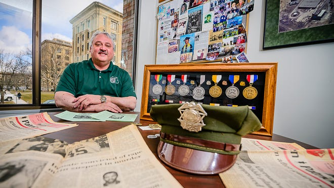 Michigan Corrections Organzation President Tom Tylutki displays corrections officer memorabilia in his office in downtown Lansing on  Friday, March 3, 2017.