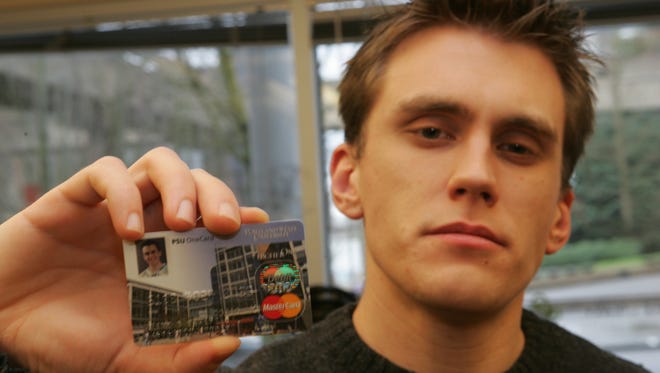 Some students struggle to find responsible ways to build credit. Here, Brad Vehafric, then 26, on the campus at  Portland State University, with his student credit card.
