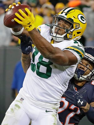 Green Bay Packers wide receiver Randall Cobb catches a touchdown pass in front of Chicago Bears cornerback Cre'von LeBlanc during Thursday's game at Lambeau Field in Green Bay.
