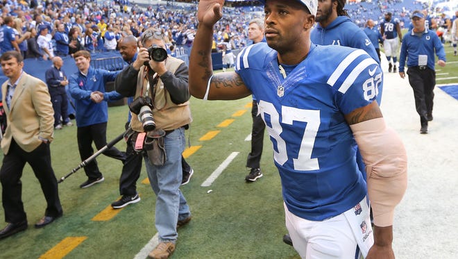 Indianapolis Colts wide receiver Reggie Wayne thanks his fans for the support as he heads to the locker room at the end of the game against Cincinnati at Lucas Oil Stadium on October 19, 2014. The Colts won 27-0 and Wayne is the 9th player in NFL history to reach 14,000 receiving yards after Sunday's performance.