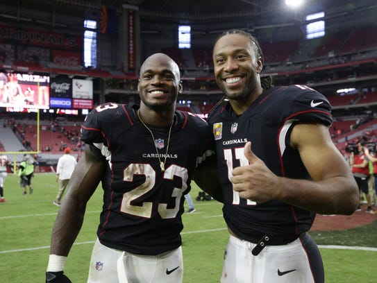 Adrian Peterson (left) and Larry Fitzgerald pose after