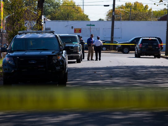 Police investigate the scene of the shooting at 28th Street Auto Sales and Services on the corner of E 28th and Northeast Boulevard in 2017.