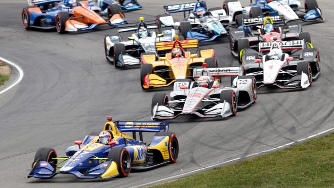 Alexander Rossi (27) leads the field through a corner at the start of the IndyCar Series auto race, Sunday, July 29, 2018, at Mid-Ohio Sports Car Course in Lexington, Ohio.