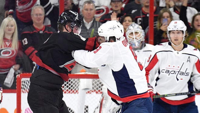 Alex Ovechkin knocks out Andrei Svechnikov during the first period of an NHL playoff game between the Washington Capitals and Carolina Hurricanes.