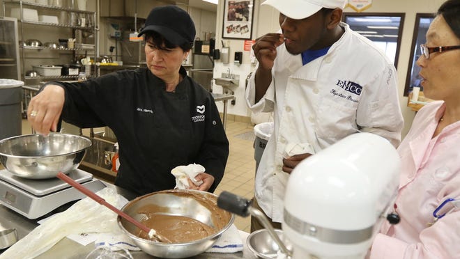 Rina Harris is a culinary arts teacher at Eastern Monroe Career Center at Boces One in Fairport. Harris tried Kyeshon Brown’s chocolate mousse who had a question about the richness. Also working with Brown is Lynn Ryder, associate assistant, in the culinary arts program.