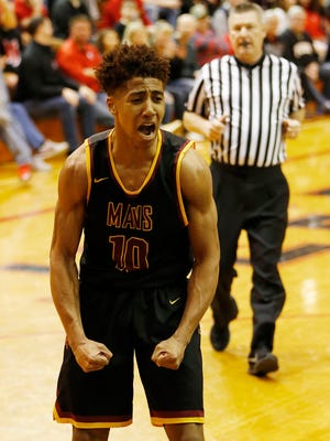 Robert Phinisee of McCutcheon lets out a scream after scoring and drawing a foul on Maximus Grimes of Lafayette Jeff the sectional semifinal Friday, March 2, 2018, in Lafayette. McCutcheon defeated Jeff 67-53 behind Phinisee’s 34 points and 14 rebounds.