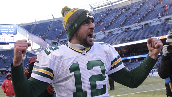 Green Bay Packers quarterback Aaron Rodgers pumps his fists after defeating the Chicago Bears on Dec. 18, 2016, at Soldier Field.