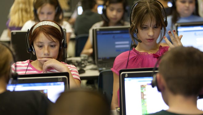Mckenzie Johnson, right, counts on her fingers while she and her fellow East Elementary School students, including Maddie Morris, left, utilize the  SuccessMaker computer program during class time Wednesday, Dec. 5, 2012 in St. George.